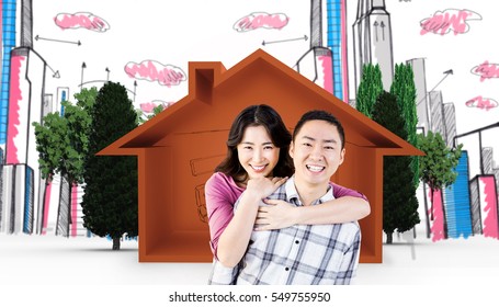 Smiling man gives girl piggy back against house shape and living room sketch