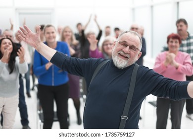 Smiling man gives a speech in meeting - Powered by Shutterstock