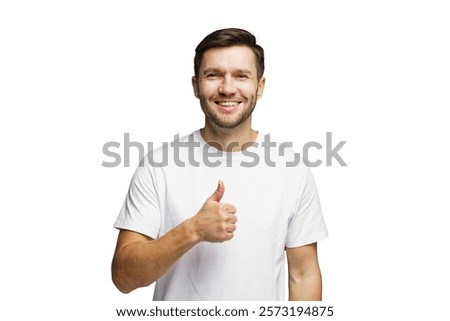 Smiling man giving a thumbs up while wearing a plain white shirt in a bright setting