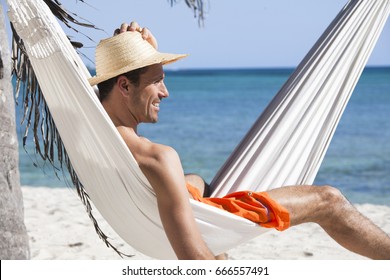 Smiling Man In A Hammock On The Beach