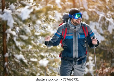 Smiling Man Hiking On Winter Snowy Mountains