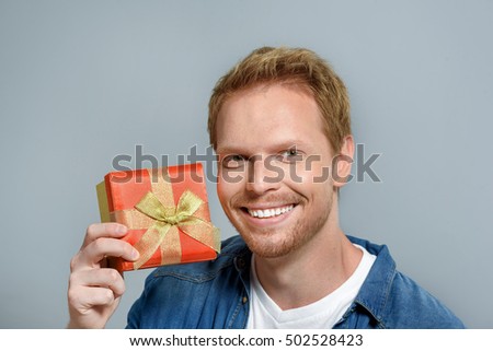 smiling man holding his gift