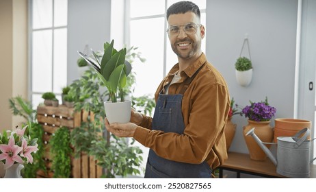 Smiling man holding plant in sunlit flower shop, conveying a sense of freshness and retail business. - Powered by Shutterstock