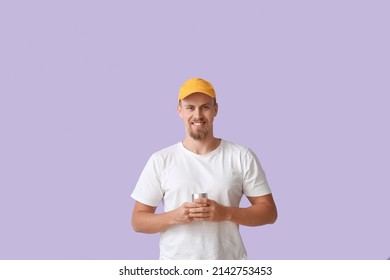 Smiling Man Holding Wireless Portable Speaker On Violet Background