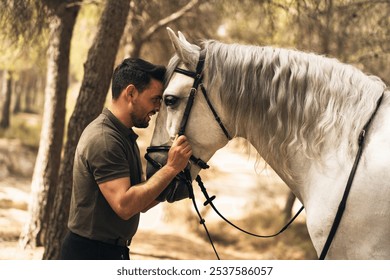 Smiling man and horse with heads facing each other. Concept of connection between man and horse. - Powered by Shutterstock