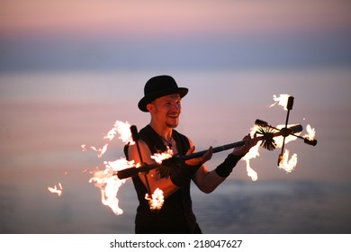 Smiling Man Juggling With Fire Torch