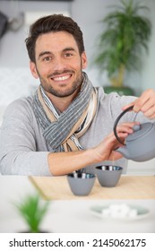 Smiling Man With Kettle Making Tea