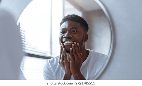 Smiling Man Looking at His Reflection in a Round Mirror in a Bright Room