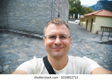 Smiling Man Making Selfie At Old City