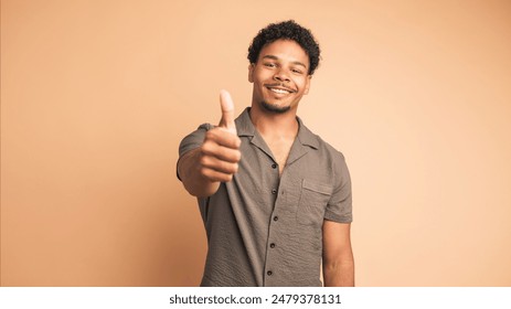 Smiling man making thumbs up gesture and nodding to show approval - Powered by Shutterstock