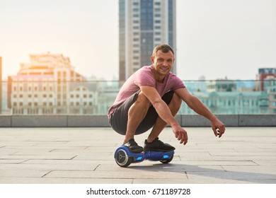 Smiling Man On Hoverboard. Guy In The City.