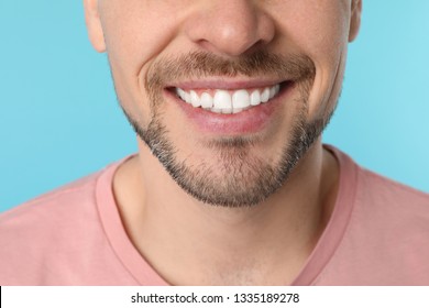 Smiling Man With Perfect Teeth On Color Background, Closeup