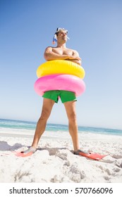 Smiling Man Posing With Rubber Ring On The Beach