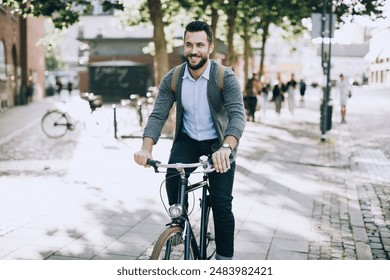 Smiling man riding bicycle in city - Powered by Shutterstock