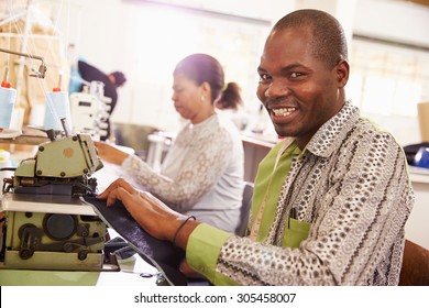 Smiling Man Sewing At A Community Workshop, South Africa