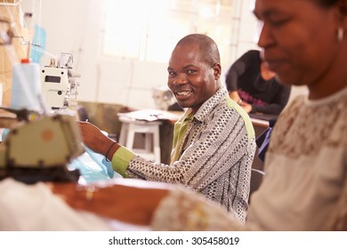 Smiling Man Sewing At A Community Workshop, South Africa