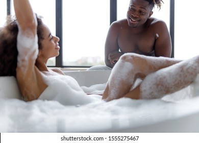Smiling man spending time with his girlfriend in bathroom stock photo