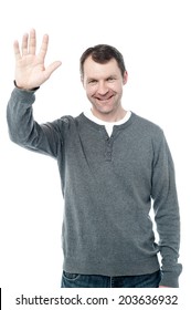 Smiling Man Standing And Waving His Hand 