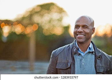 Smiling Man Stands In Park