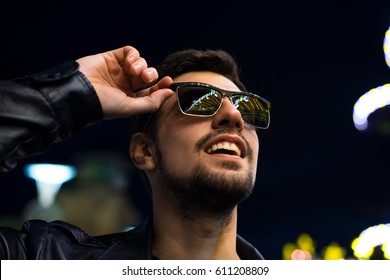 Smiling Man In Sunglasses With Colorful Reflection Of Night Lights. Night City Life