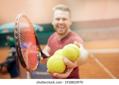 Smiling Man Trainer Player Prepares To Serve Tennis Ball During Match Court.