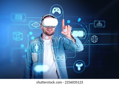 Smiling man in vr headset finger touching cyberspace hologram with glowing icons circuit. Concept of virtual world and immersive technology - Shutterstock ID 2256035123