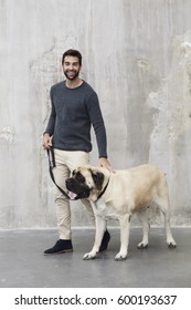 Smiling Man Walking Dog In Studio