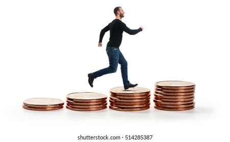 smiling man walking on Stack of coins isolated on white. Business Growth concept