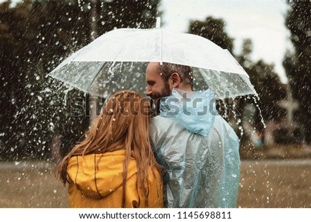 Similar – Image, Stock Photo Content woman under umbrella on beach in summer looking at camera
