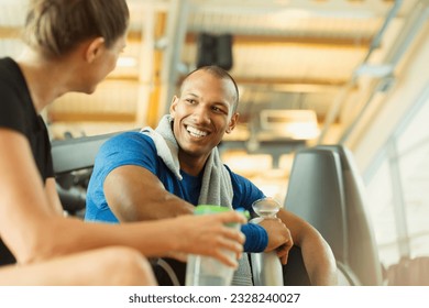 Smiling man and woman talking at gym - Powered by Shutterstock