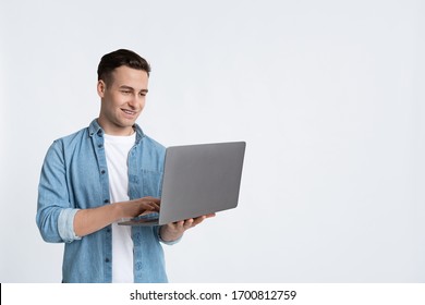 Smiling man working with laptop isolated on white background