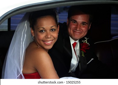 smiling married bi-racial couple in limousine - Powered by Shutterstock