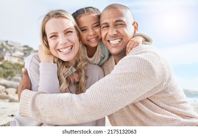 Smiling married couple bonding with daughter on the beach. Adopted little girl embracing her parents on a beachside vacation. Happy husband and wife enjoying free time with their child - Powered by Shutterstock