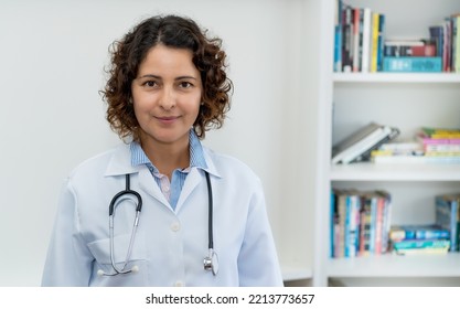 Smiling Mature Adult Doctor With Copy Space Indoors At Office