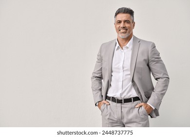 Smiling mature business man leader isolated on white background, portrait. Happy middle aged businessman ceo entrepreneur wearing suit, confident 45 years old professional executive looking at camera.