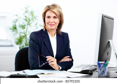 Smiling mature business woman. In a modern office.