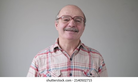 Smiling Mature Casual Hispanic Man With Glasses Looking At Camera.