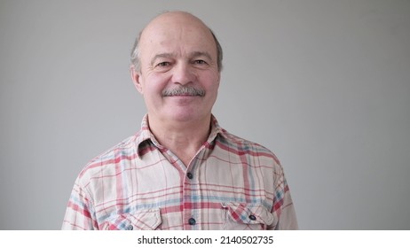 Smiling Mature Casual Hispanic Man With Glasses Looking At Camera.