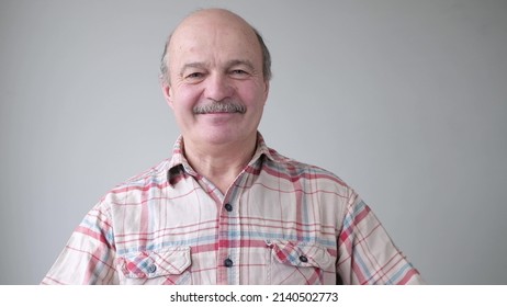 Smiling Mature Casual Hispanic Man With Glasses Looking At Camera.