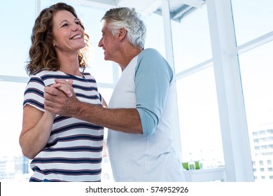 Smiling Mature Couple Dancing At Cafe