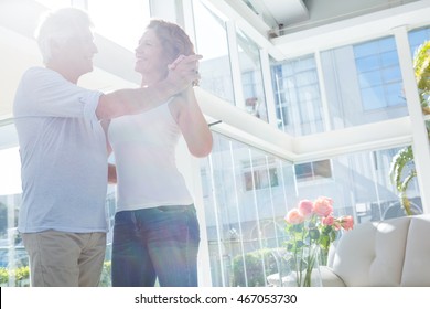 Smiling Mature Couple Dancing At Home