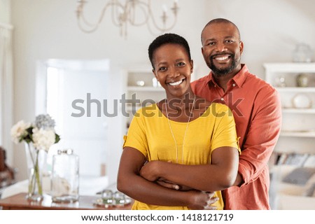 Similar – Image, Stock Photo A middle-aged couple hugging each other and observing a sunset sea, we see them from the back