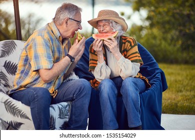 Smiling Mature Couple On Romantic Vacation Eating Watermelon