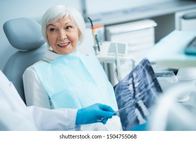 Smiling Mature Lady Listening Her Dentist Stock Photo