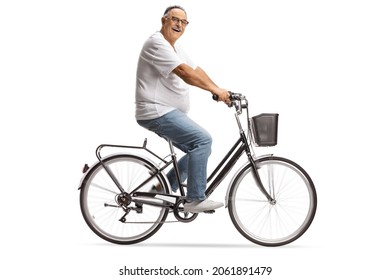 Smiling mature man in jeans and white t-shirt riding a bicycle isolated on white background - Powered by Shutterstock