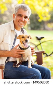 Smiling Mature Man And Pet Dog Outdoors