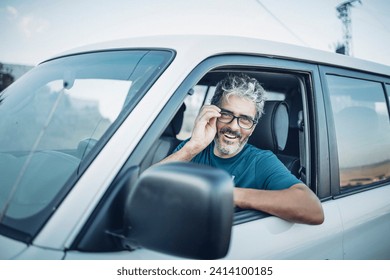 Smiling mature man sitting in his off-road vehicle - Powered by Shutterstock