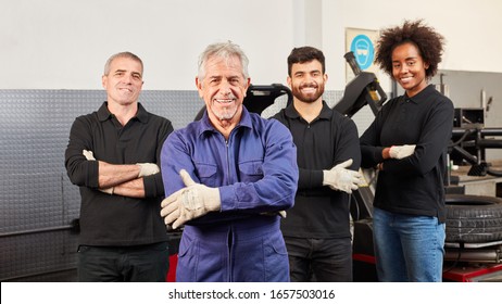 Smiling Mechanic And Mechatronics Team In A Car Workshop