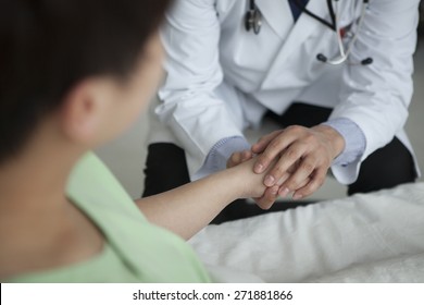 Smiling Medical Doctor Shaking Hands With Happy Patient