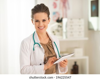 Smiling medical doctor woman using tablet pc